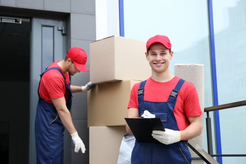 Removal team handling boxes on a Sutton residential street