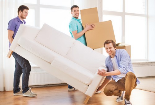 Team member following safe lifting practices during a removal