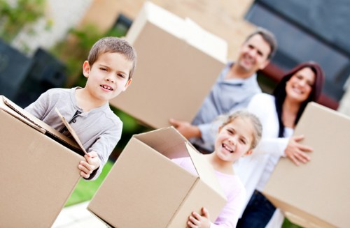 Packed boxes and furniture being loaded into a moving truck