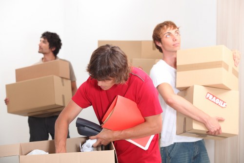 Furniture pick-up team handling bulky items in a Sutton home
