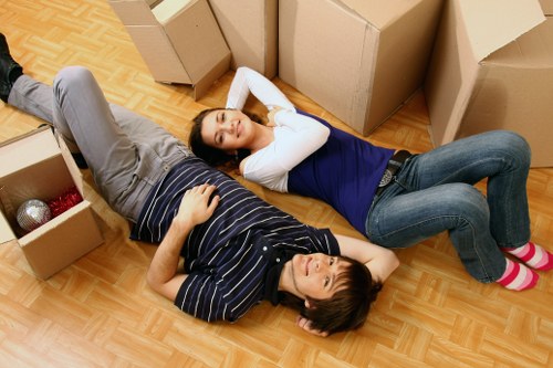 Boxes and furniture being loaded into a local removal van